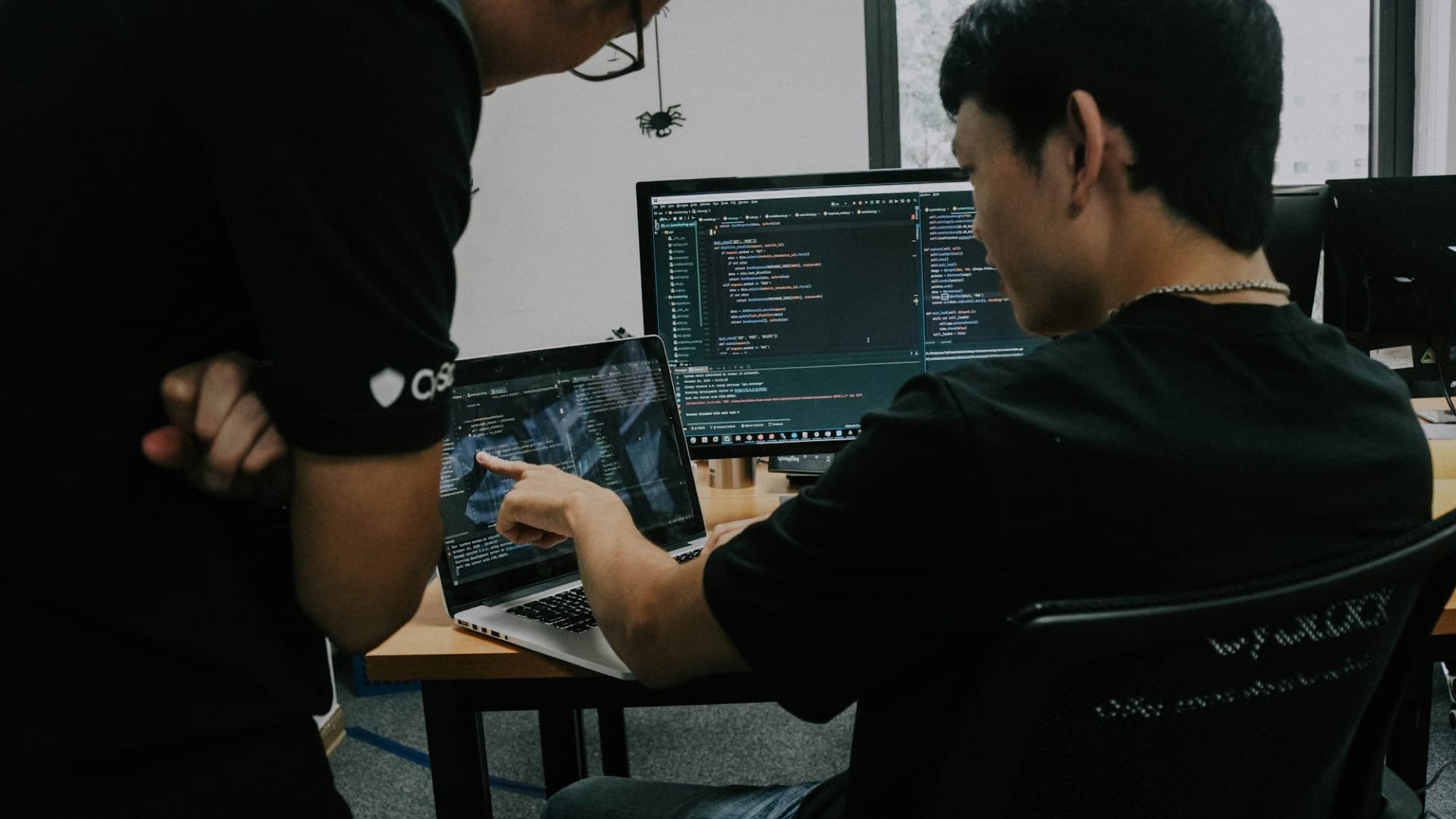 Two engineers reviewing code together